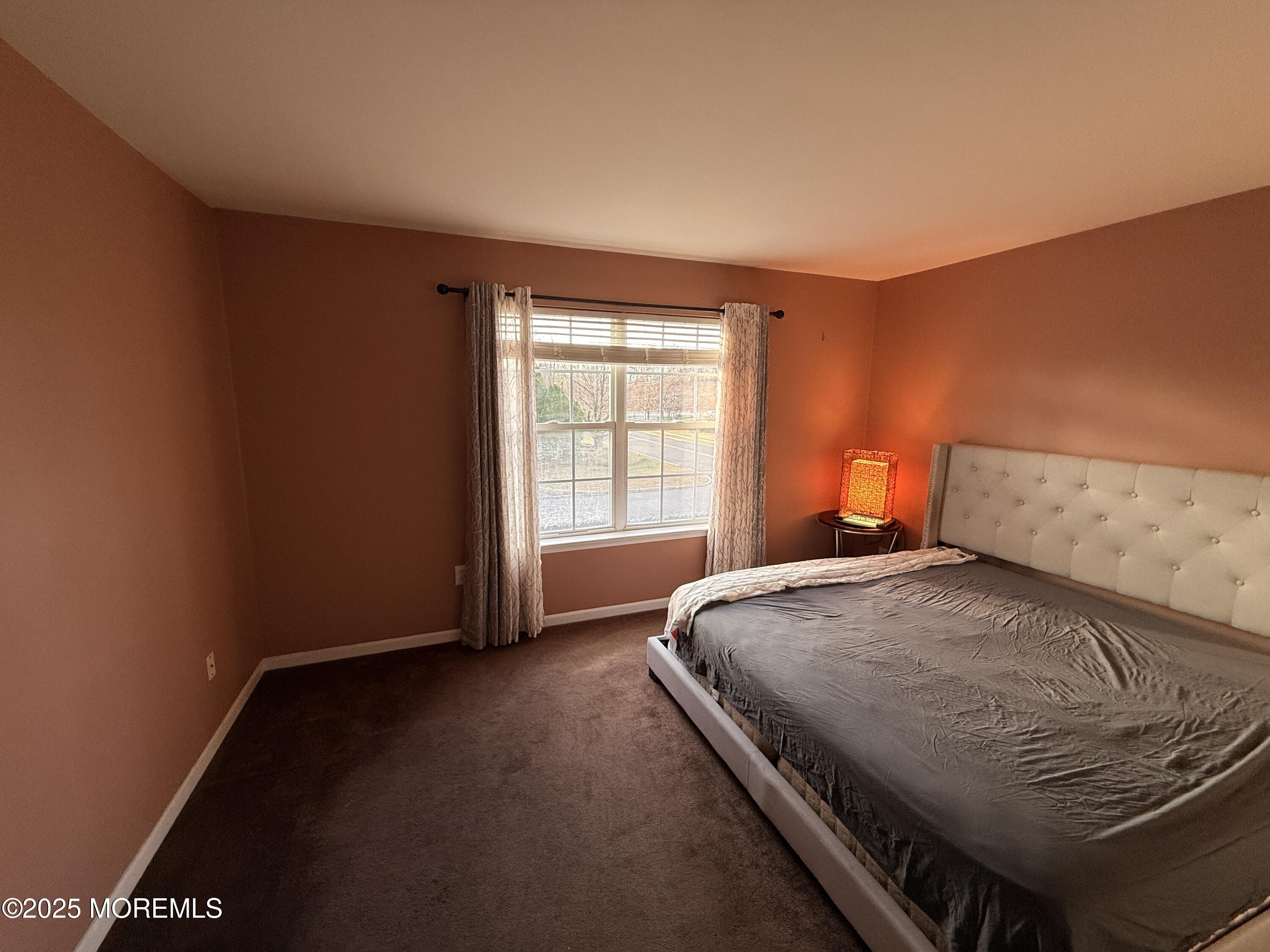 1811 Bellmore Street Oakhurst, NJ 07755 - Photo 19 of 49 a bedroom with a bed and window