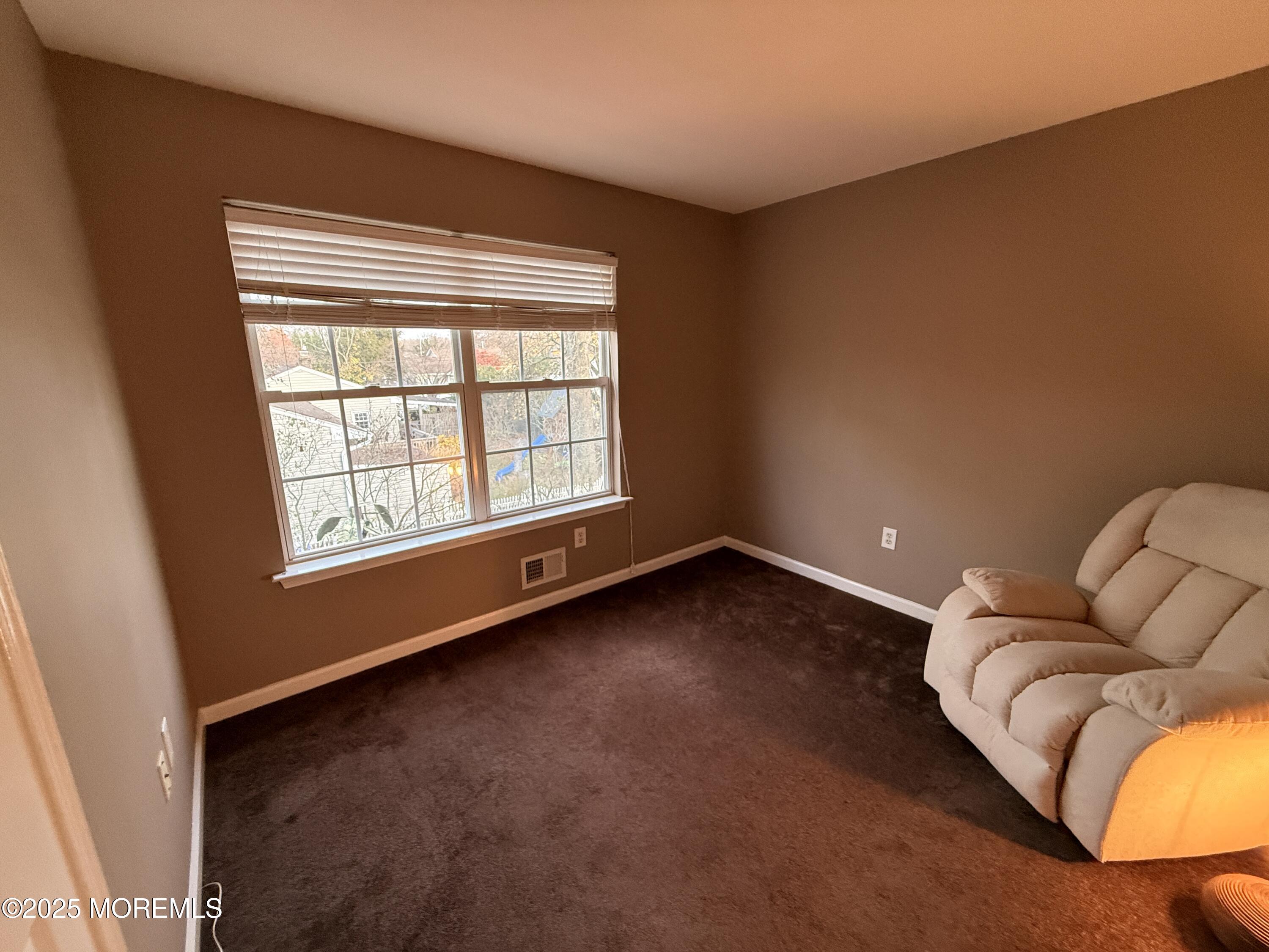1811 Bellmore Street Oakhurst, NJ 07755 - Photo 20 of 49 an empty room with wooden floor and windows