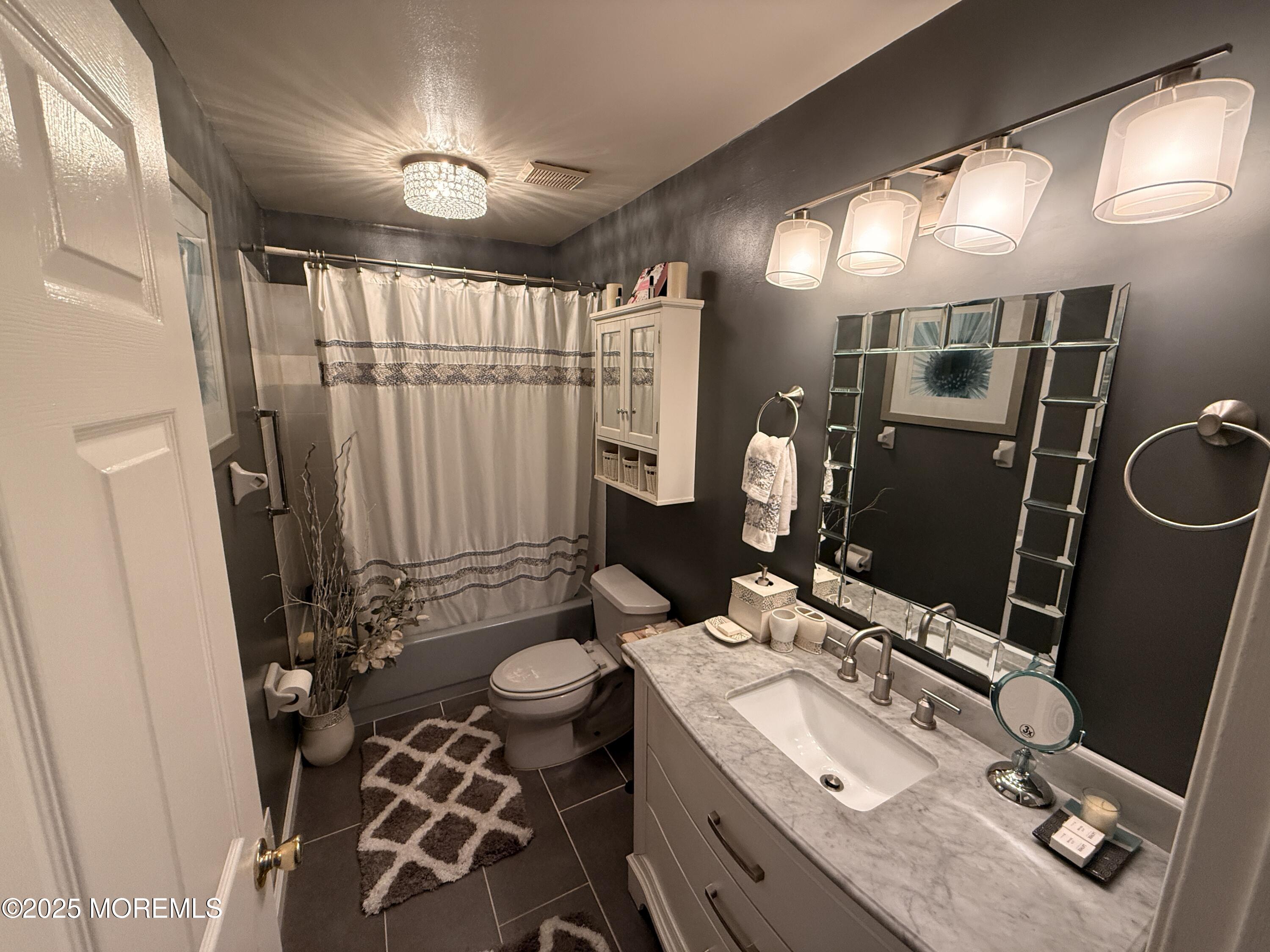 1811 Bellmore Street Oakhurst, NJ 07755 - Photo 23 of 49 a bathroom with a double vanity sink mirror and toilet