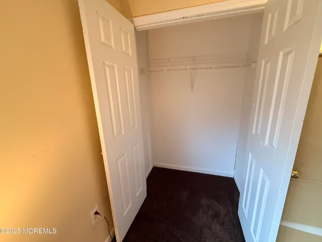 a bedroom with a bed and cabinets