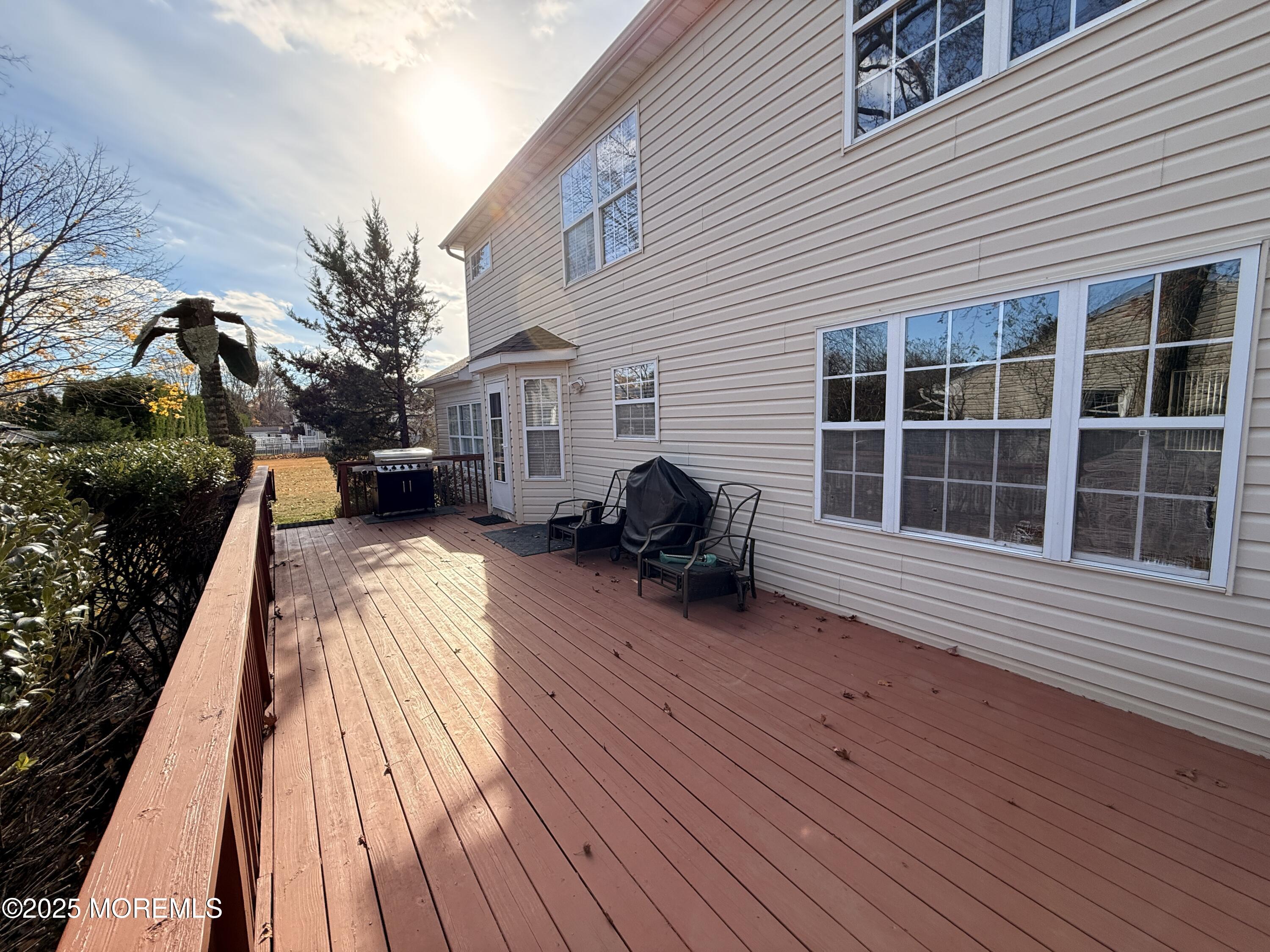 1811 Bellmore Street Oakhurst, NJ 07755 - Photo 33 of 49 a view of a house with a barbeque and wooden floor