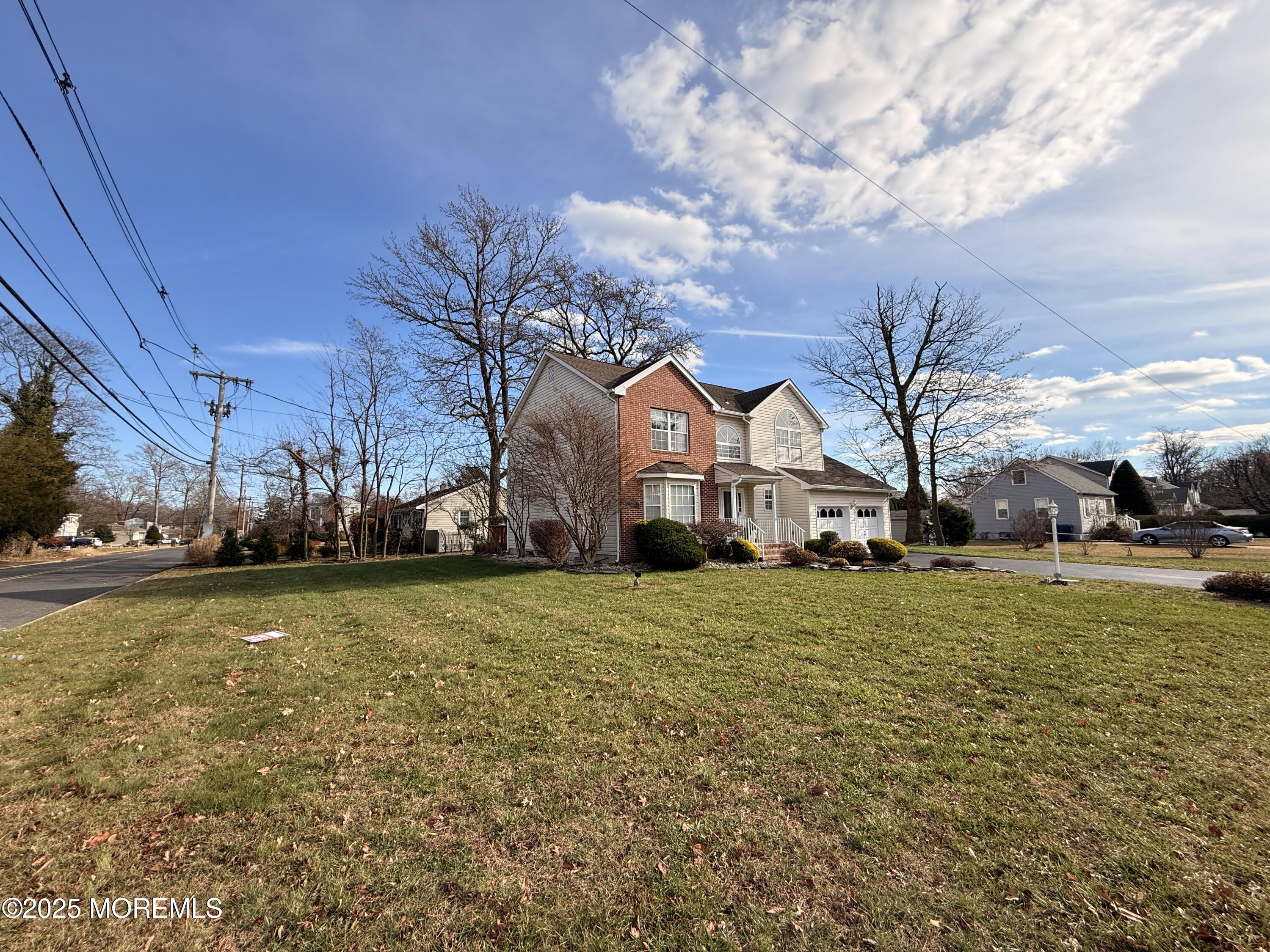 1811 Bellmore Street Oakhurst, NJ 07755 - Photo 34 of 49 a view of a big house with a big yard and large trees