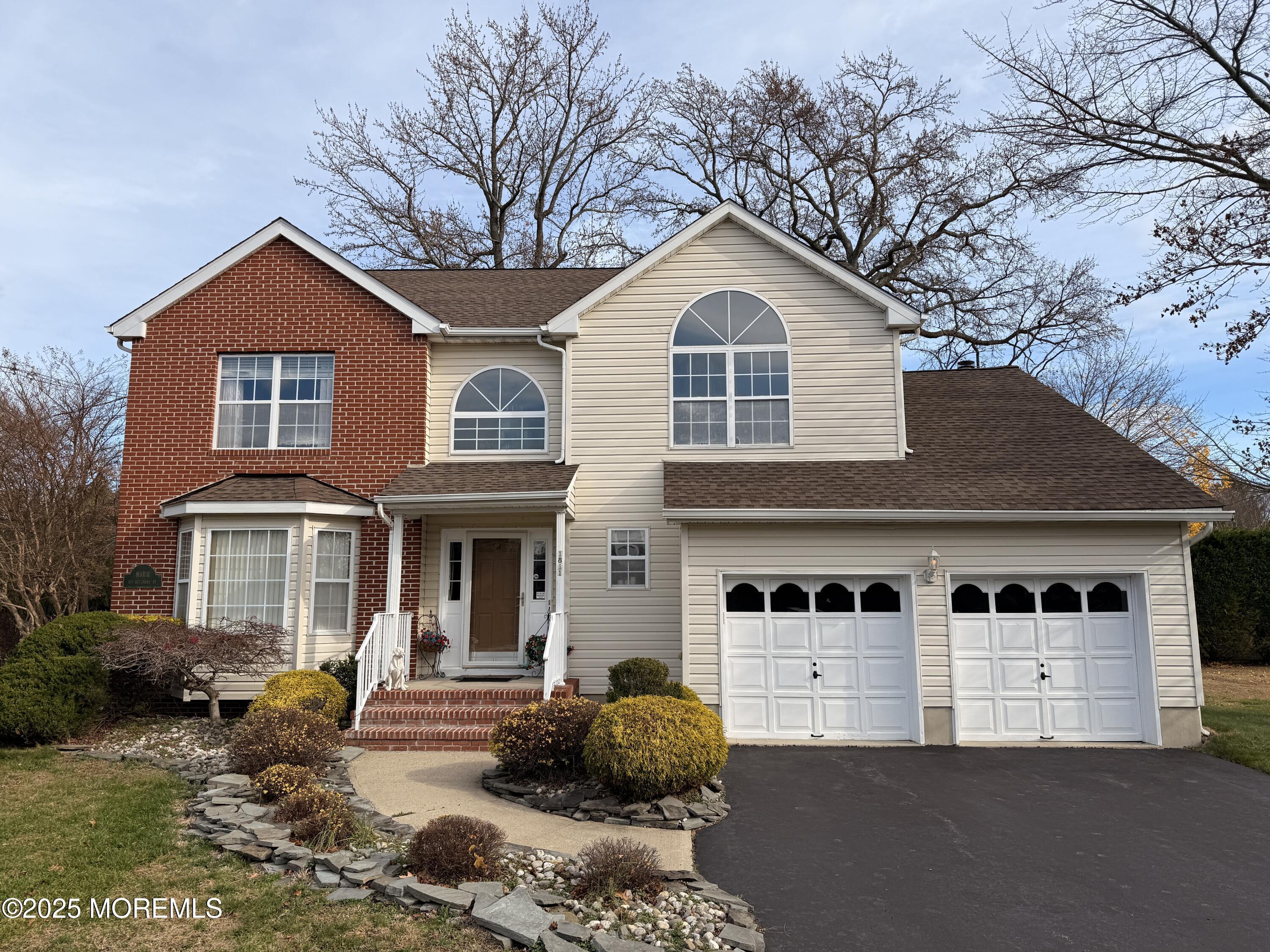 1811 Bellmore Street Oakhurst, NJ 07755 - Photo 38 of 49 a front view of a house with garden