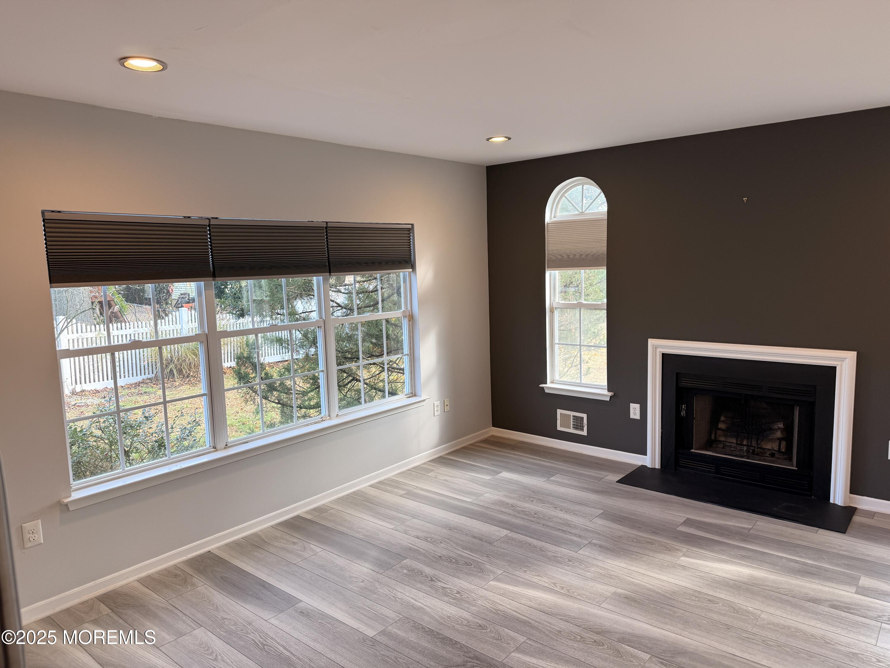 1811 Bellmore Street Oakhurst, NJ 07755 - Photo 42 of 49 a view of an empty room with a fireplace and a window