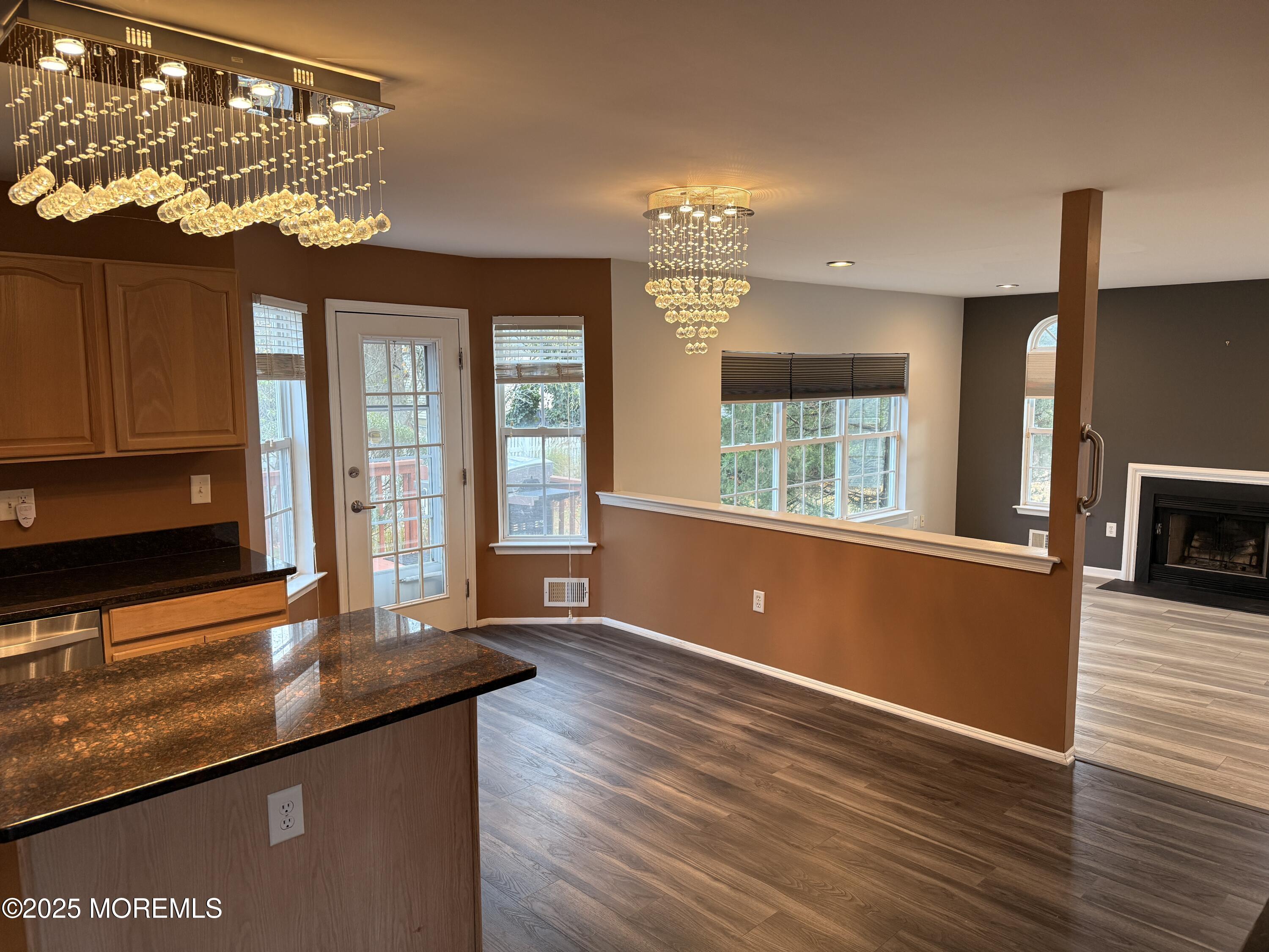 1811 Bellmore Street Oakhurst, NJ 07755 - Photo 44 of 49 a kitchen with kitchen island a sink wooden floor and a large window