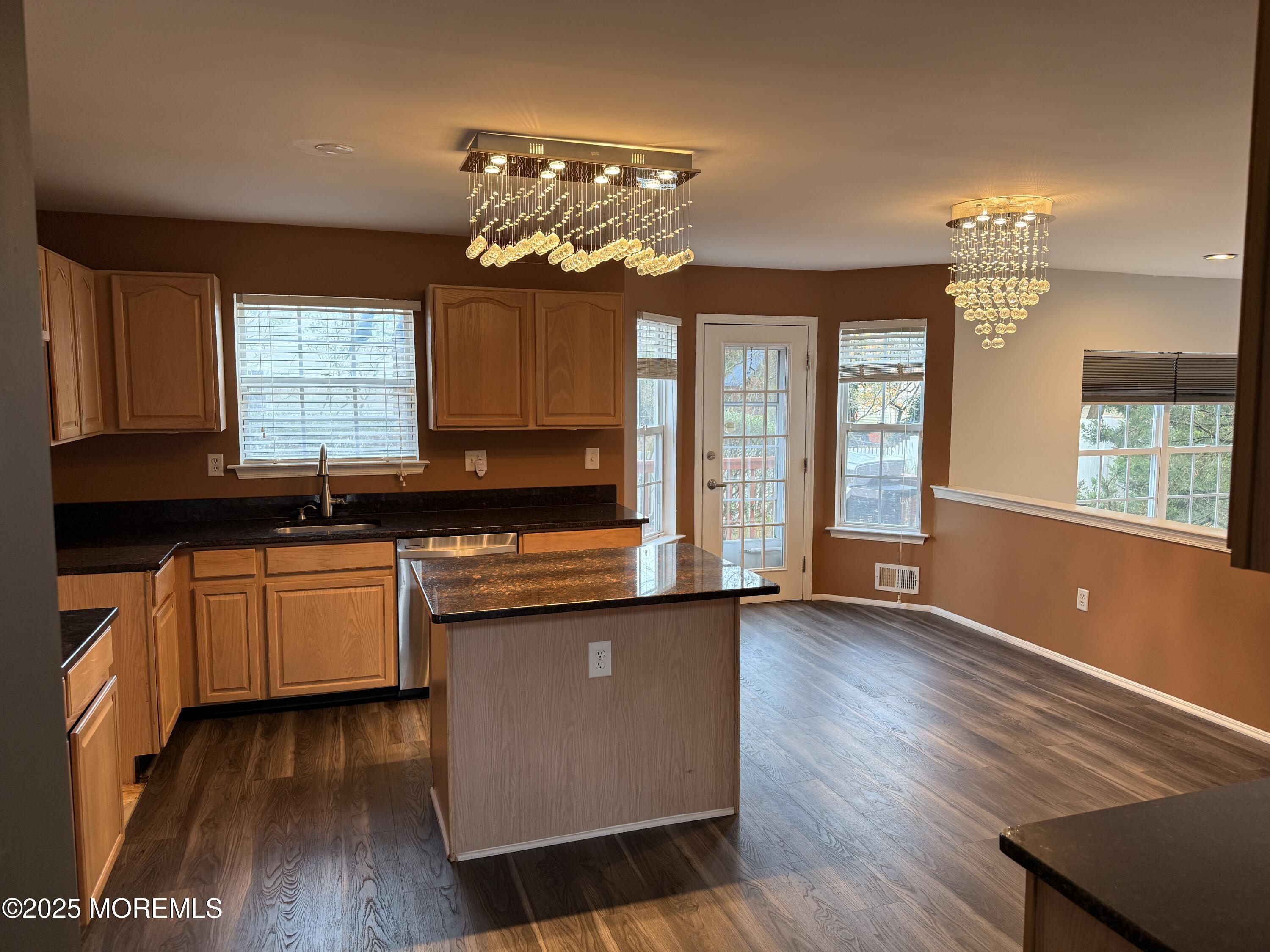 1811 Bellmore Street Oakhurst, NJ 07755 - Photo 46 of 49 a kitchen with granite countertop wooden floors and wide window