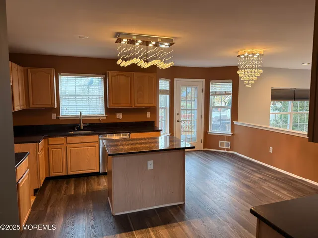 a kitchen with stainless steel appliances granite countertop a sink stove and microwave