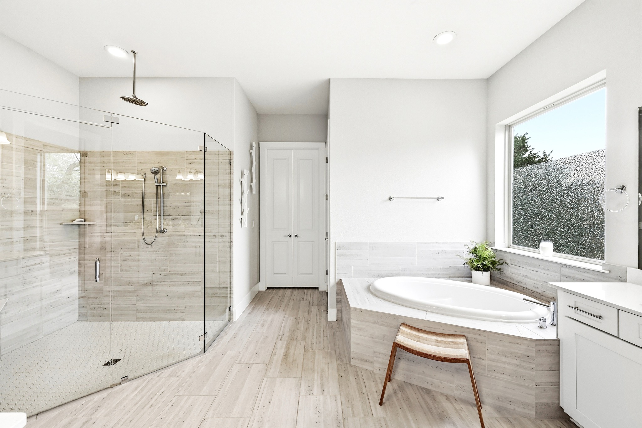 9008 Harper Rae Drive Austin, TX 78717 - Photo 20 of 39 Spacious bathroom featuring a frameless glass shower enclosure, a separate built-in soaking tub, and plank-style tile flooring