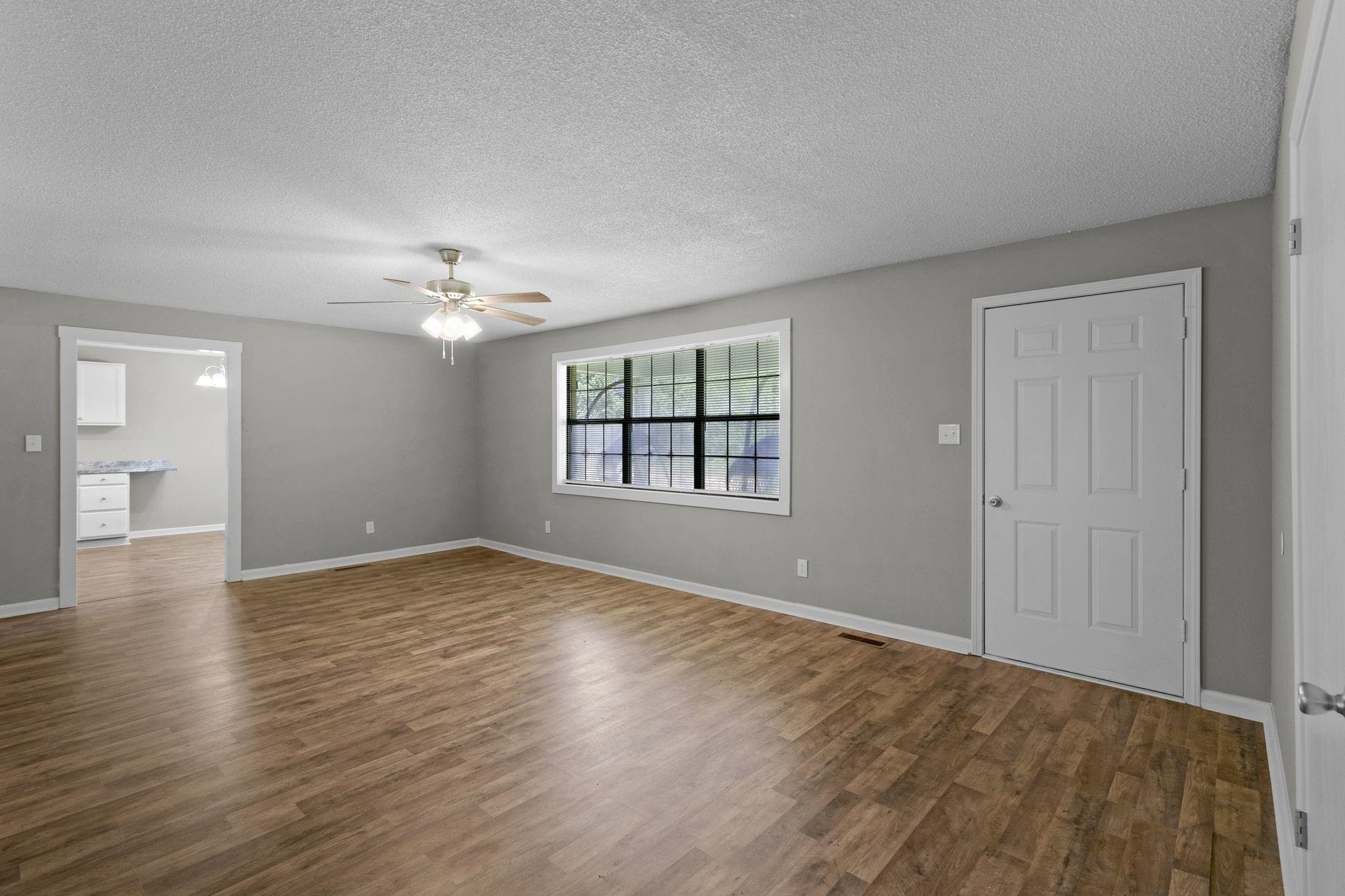 1000 Crucifer Road Huron, TN 38345 - Photo 6 of 21 a view of an empty room with wooden floor and a window