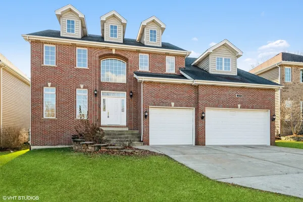 front view of a house with a yard