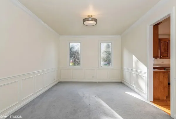 an empty room with windows and entrance
