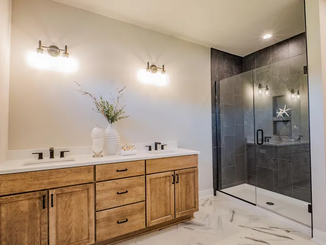 a bathroom with a shower sink and mirror