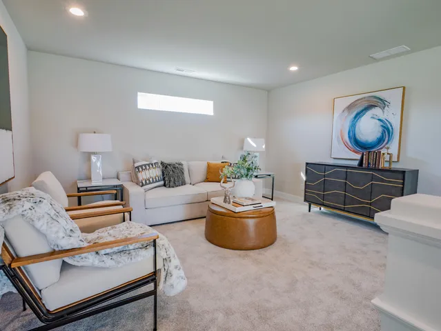 a living room with furniture and a chair