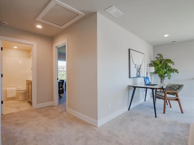a view of room with furniture and a potted plant