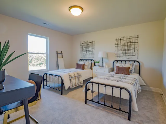 a bedroom with two beds and a table