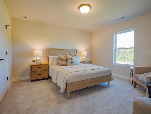 a spacious bedroom with a bed and a couch