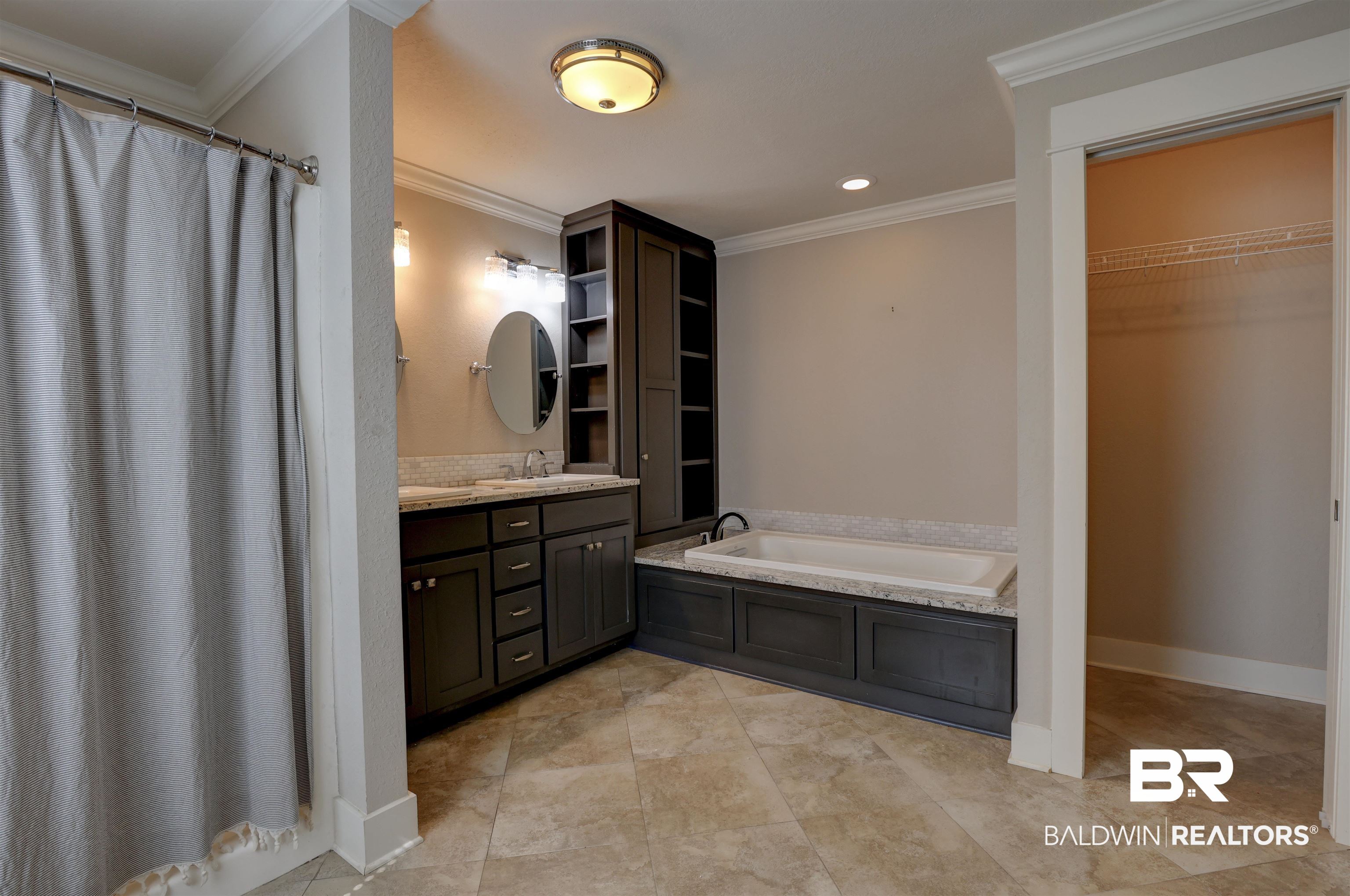 2079 Alabama Street Loxley, AL 36551 - Photo 19 of 42 Bathroom with crown molding, tile patterned flooring, and a bathtub
