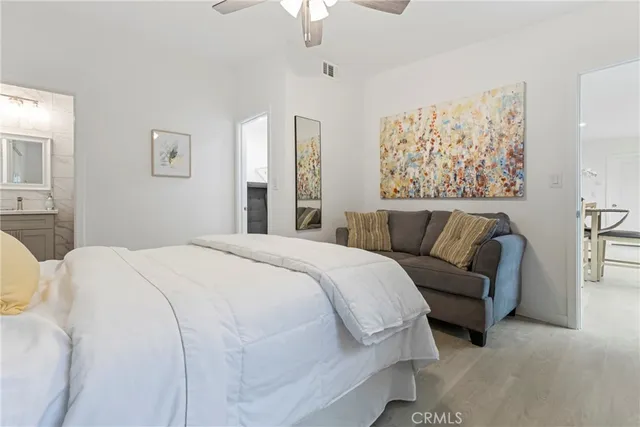 a bedroom with a bed and a potted plant