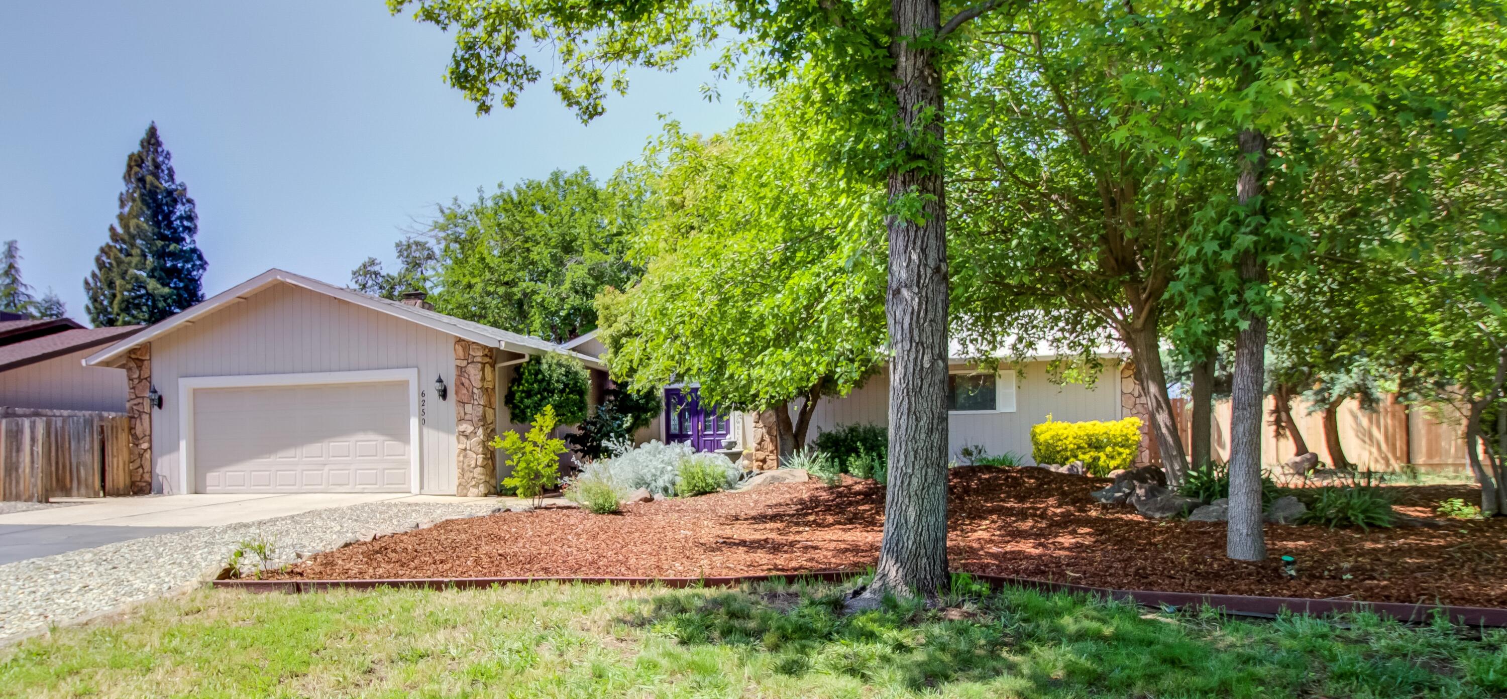 6250 Riverside Drive Redding, CA 96001 - Photo 1 of 28 a front view of a house with garden