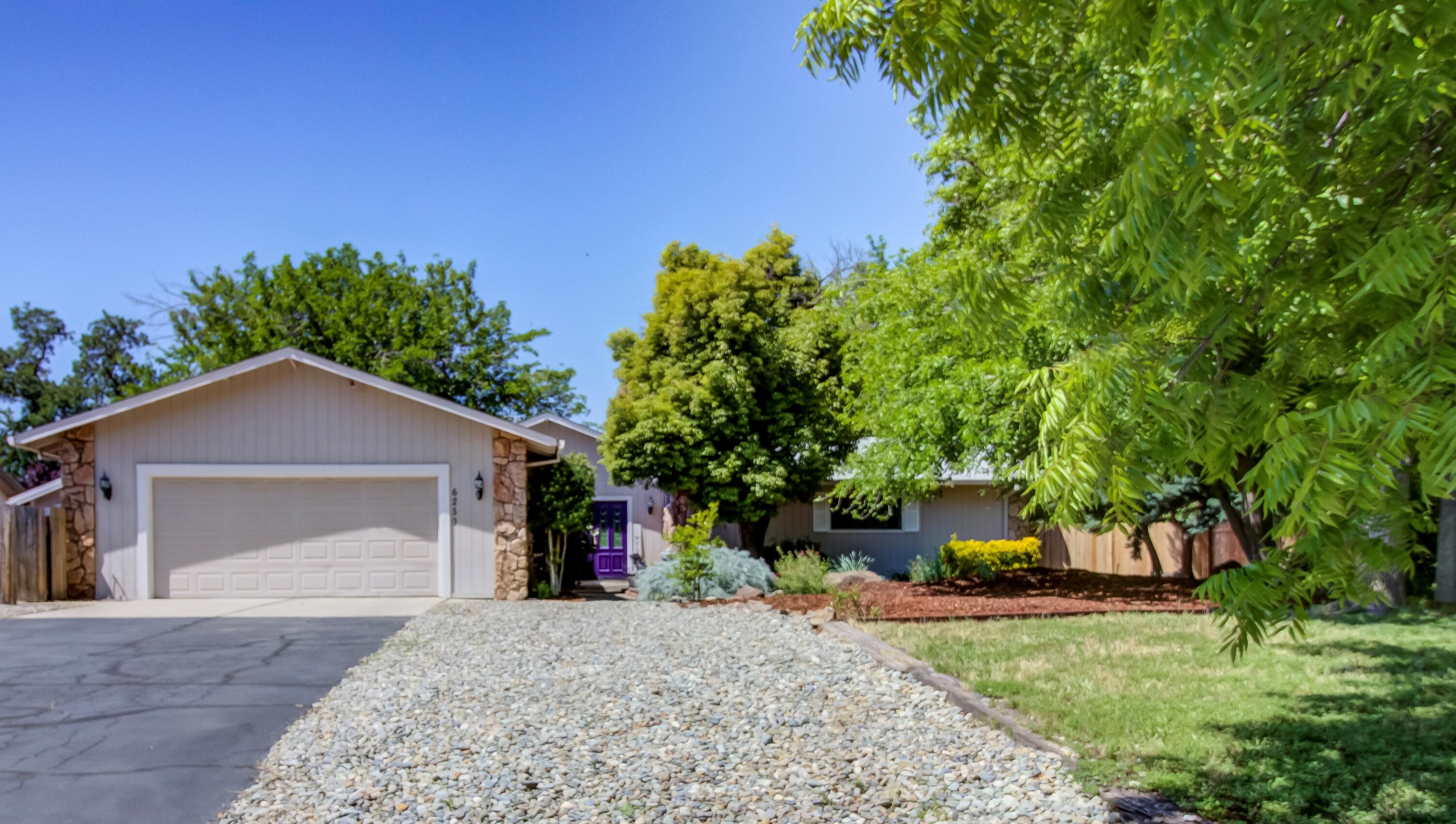 6250 Riverside Drive Redding, CA 96001 - Photo 23 of 28 a front view of a house with a yard and garage