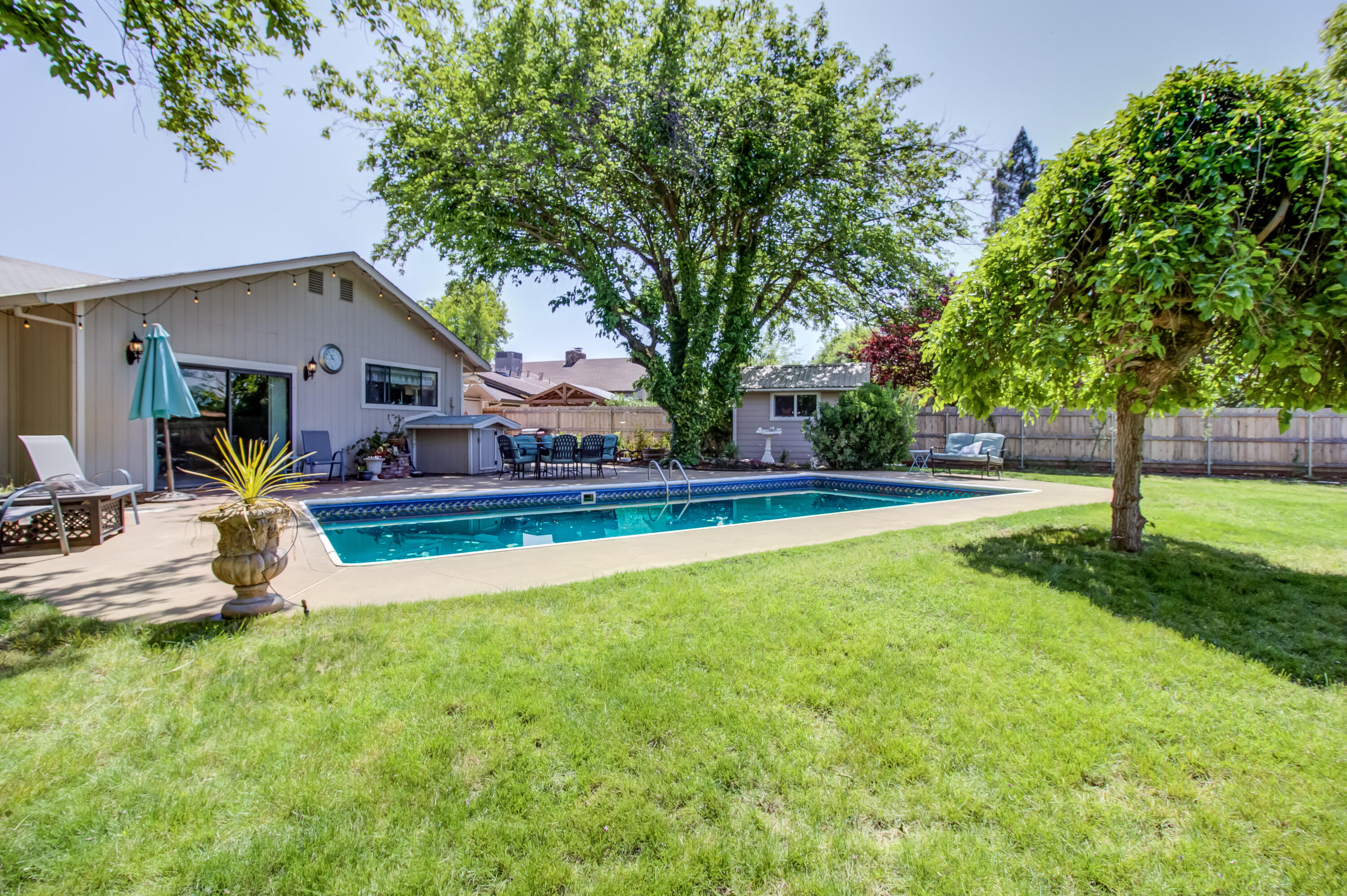 6250 Riverside Drive Redding, CA 96001 - Photo 3 of 28 a view of a house with swimming pool and sitting area