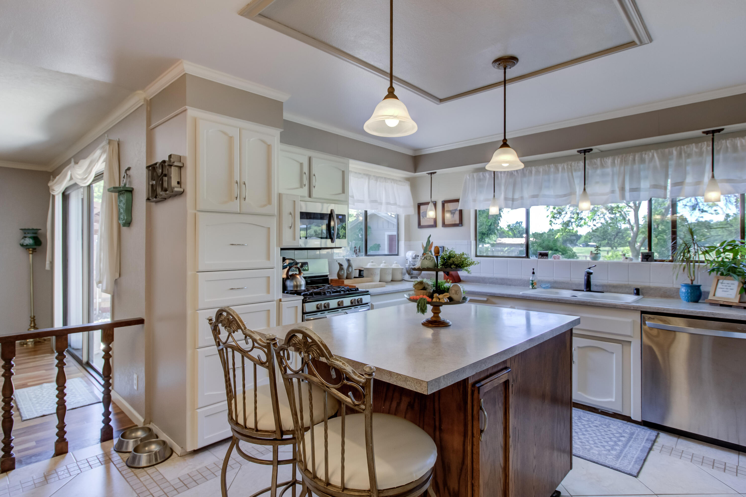 6250 Riverside Drive Redding, CA 96001 - Photo 8 of 28 a kitchen with stainless steel appliances a table chairs stove and refrigerator