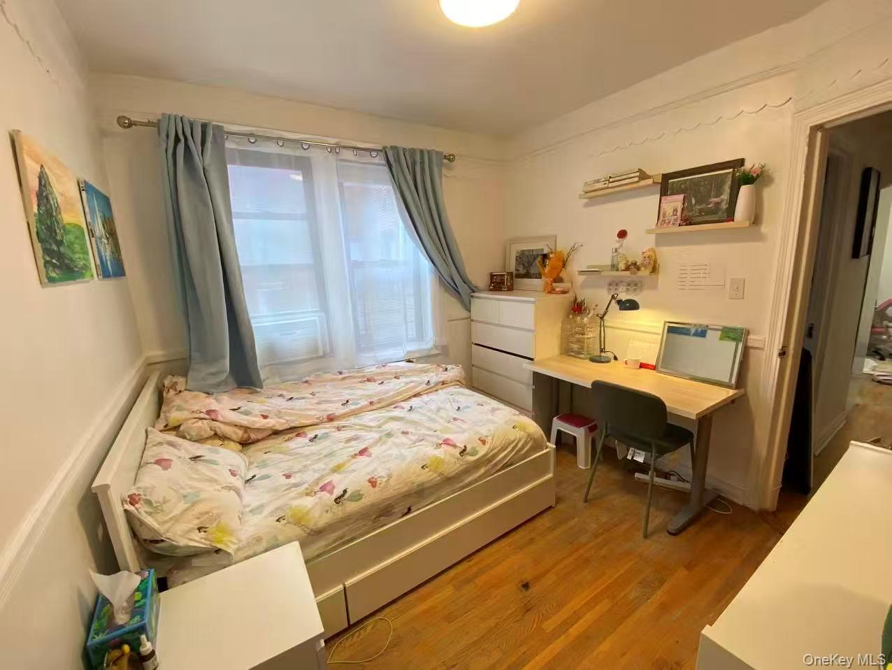 42-52 Layton Street, Unit 6F Queens, NY 11373 - Photo 7 of 10 a bed room with a bed and a desk