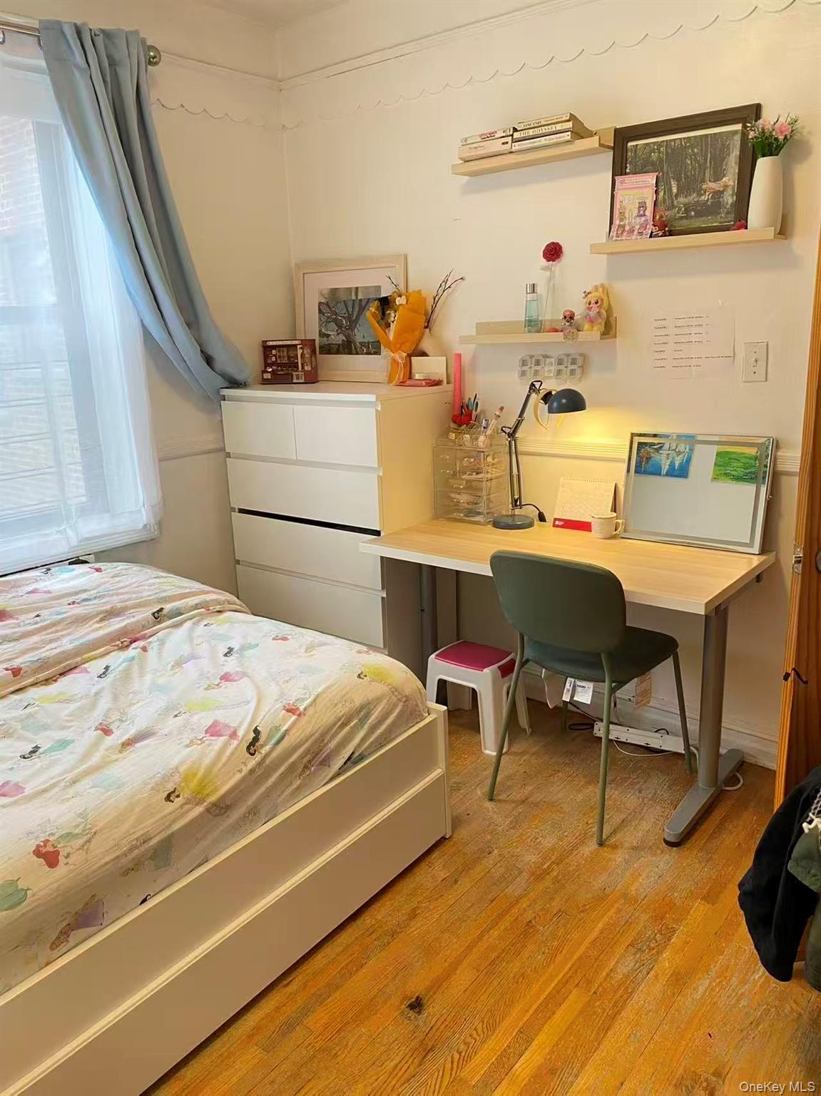 42-52 Layton Street, Unit 6F Queens, NY 11373 - Photo 8 of 10 a bedroom with a bed and a desk