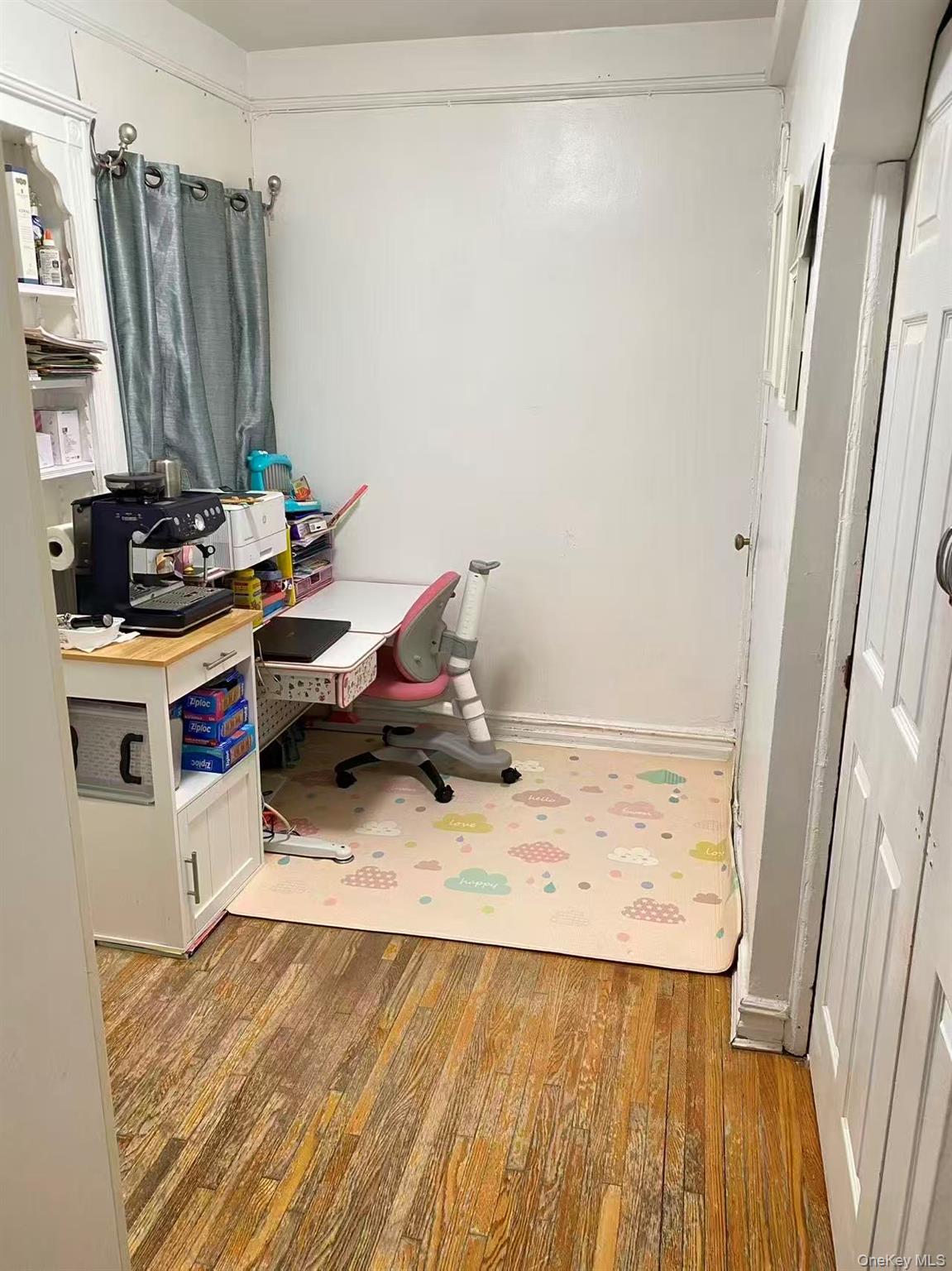 42-52 Layton Street, Unit 6F Queens, NY 11373 - Photo 9 of 10 a view of a kitchen with a sink and wooden floor