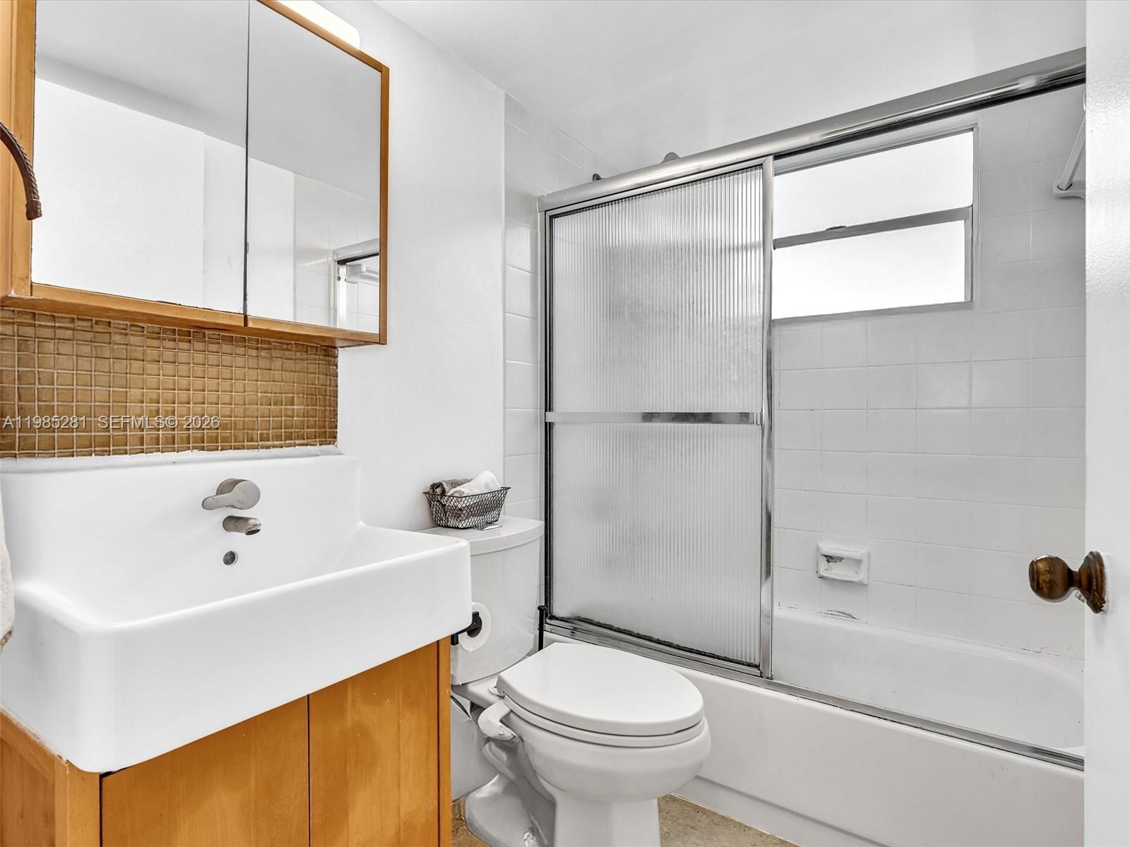 1236 Alton Road, Unit 304 Miami Beach, FL 33139 - Photo 20 of 28 a bathroom with a sink toilet and shower