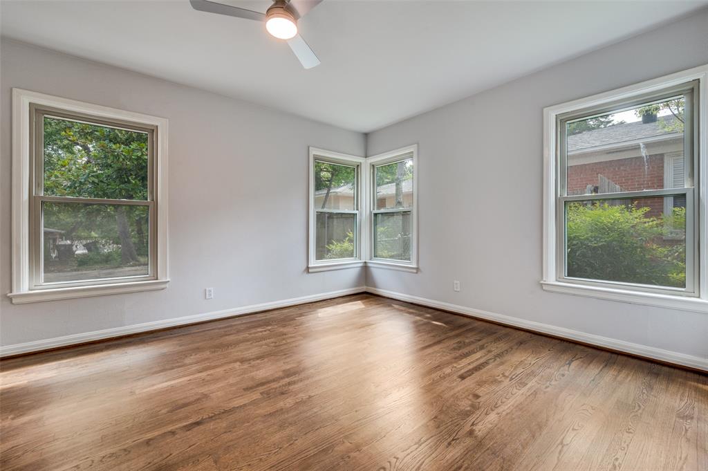 1342 Michigan Avenue Dallas, TX 75216 - Photo 17 of 25 Empty room featuring wood finished floors, healthy amount of natural light, and ceiling fan