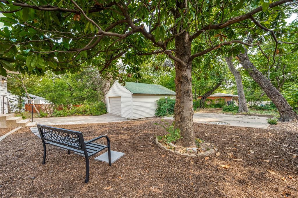 1342 Michigan Avenue Dallas, TX 75216 - Photo 24 of 25 View of yard featuring an outbuilding, a patio area, driveway, and a detached garage