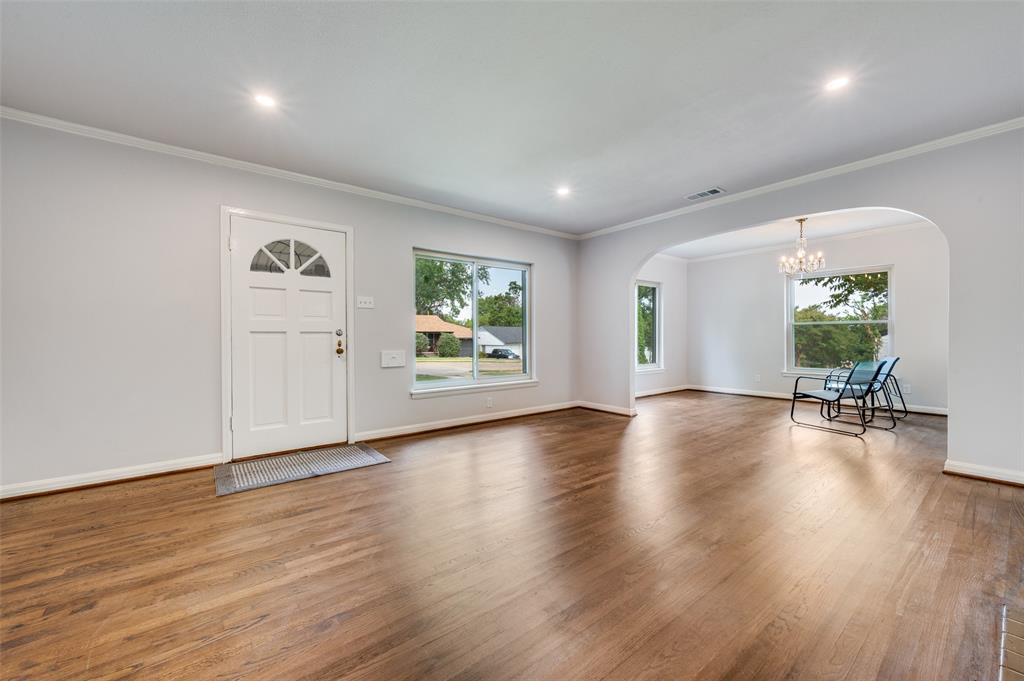 1342 Michigan Avenue Dallas, TX 75216 - Photo 6 of 25 Entrance foyer featuring arched walkways, crown molding, wood finished floors, a chandelier, and plenty of natural light