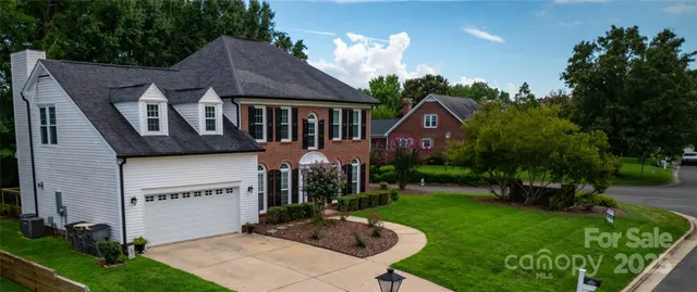 a front view of house with a garden and patio