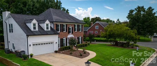 a front view of house with a garden and patio