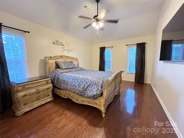 a bathroom with a granite countertop sink a toilet and a mirror