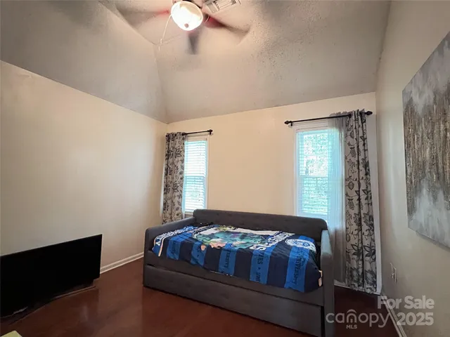 an aerial view of a house with garden space and street view