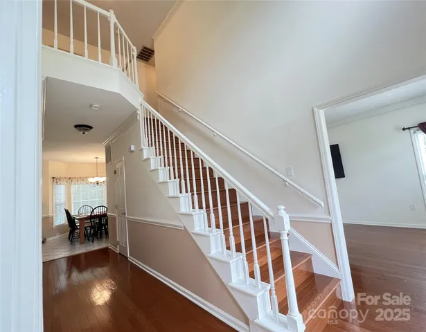 a kitchen with granite countertop a sink a stove and cabinets