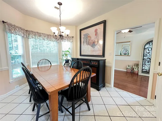 a view of a livingroom with wooden floor and a flat screen tv
