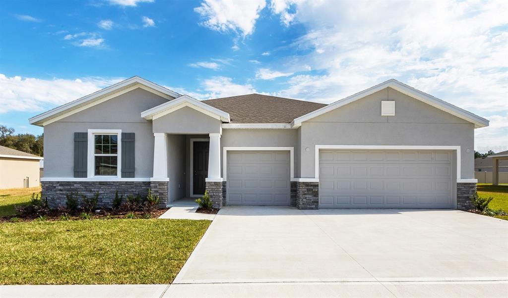 8072 Southwest 59th Terrace Ocala, FL 34476 - Photo 21 of 21 a front view of a house with a yard and garage