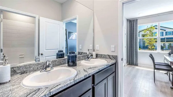 a bathroom with a granite countertop sink and a mirror