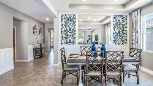 a view of a dining room with furniture and chandelier