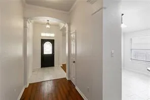 a view of a hallway with wooden floor