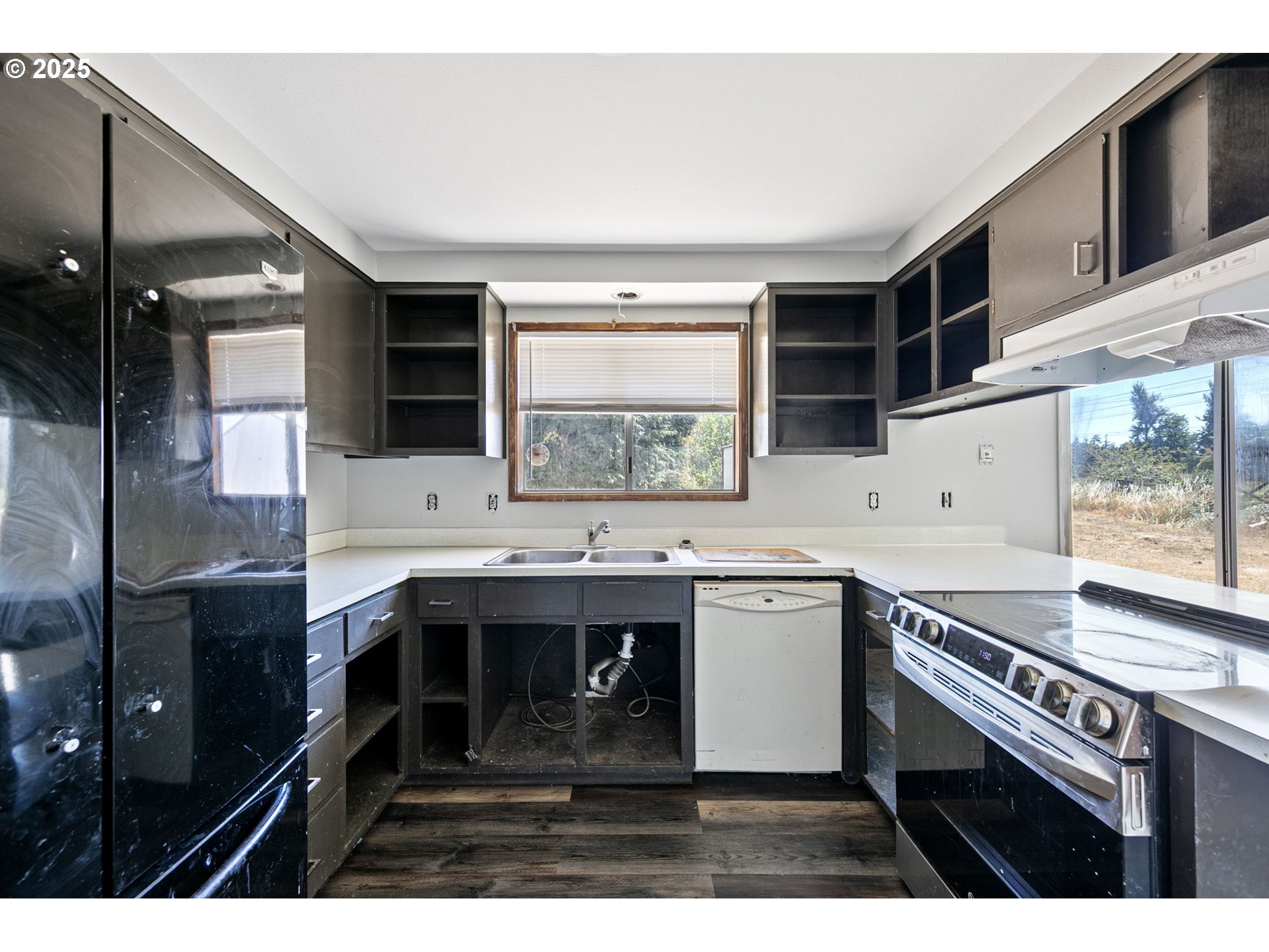 34879 Seavey Loop Road Eugene, OR 97405 - Photo 11 of 34 a kitchen with a sink stove and cabinets