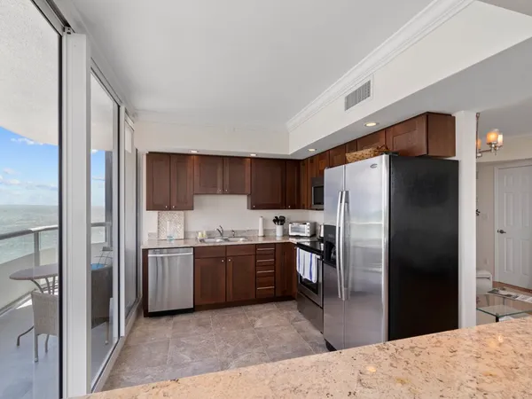 a kitchen with a sink cabinets and appliances