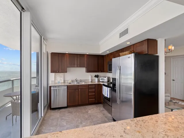 a kitchen with a sink cabinets and appliances