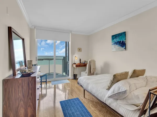 a bedroom with a bed and glass door