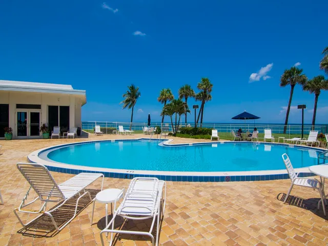 a view of a swimming pool with chairs