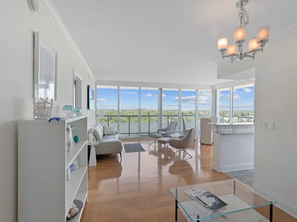 a living room with furniture and large windows