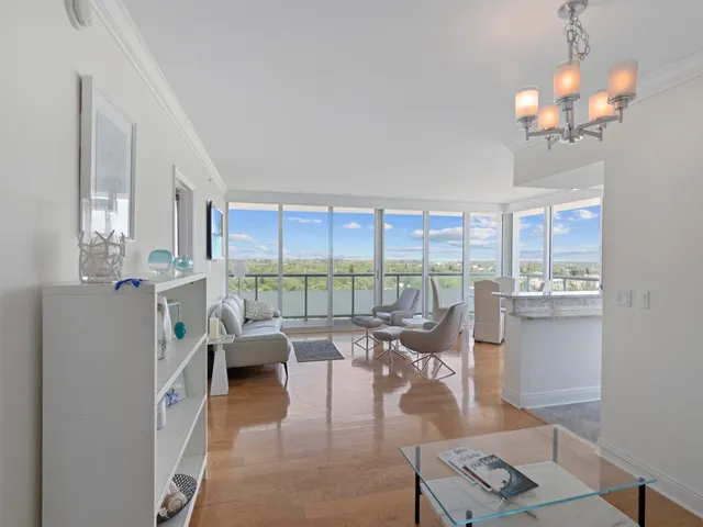 a living room with furniture and large windows